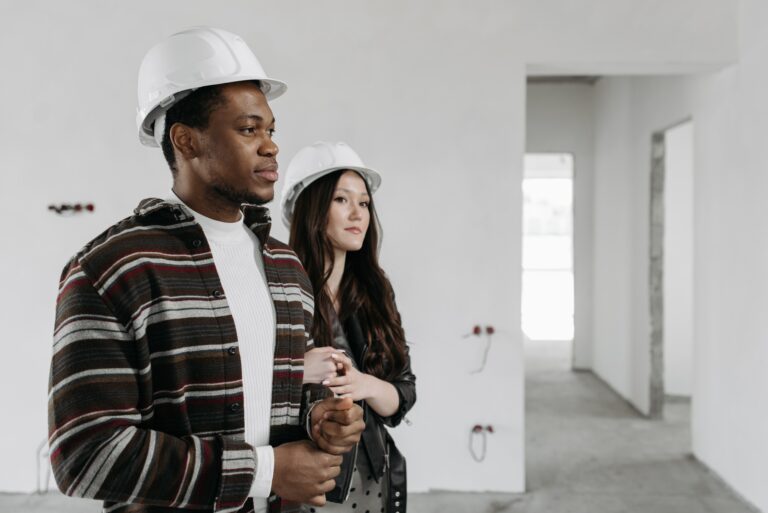 Couple in a house with hard hats